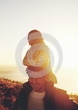 Go on an adventure. Shot of a father carrying his little girl on his shoulders while walking outdoors.