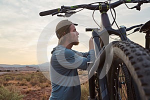 Go on adventures but dont forget to take your bike along. a young man out mountain biking during the day.