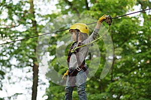 Go Ape Adventure. Adventure climbing high wire park. Child. Happy child boy calling while climbing high tree and ropes