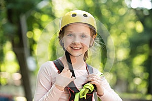 Go Ape Adventure. Happy Little girl climbing on a rope playground outdoor. Little girl concept. High ropes walk. Early