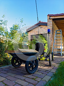 Go-cart in backyard filled with wood to help in construction