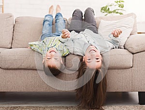 Go crazy together. Relaxing upside down on sofa