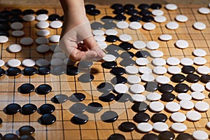 Go game or Weiqi Wei-chi - traditional Chinese board game.