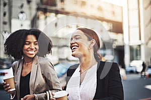 These go getters commute to work together. two businesswomen walking in the city.