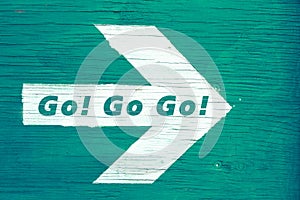 `Go! Go Go!` text written on a white directional arrow photo