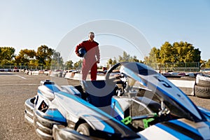 Go-kart driver walking to car before race at starting line