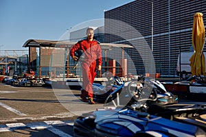 Go-kart driver walking to car before race at starting line