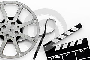 Go to the cinema with film type and clapperboard on white background top view