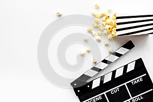 Go to the cinema with popcorn and clapperboard on white background top view mockup