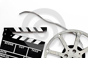 Go to the cinema with popcorn, film type and clapperboard on white background top view