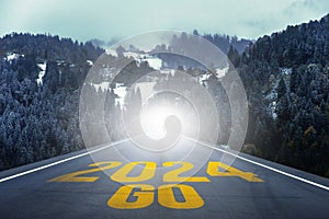 Go to the New Year 2024 concept. Number of the old year written on highway road in the middle of empty asphalt road through the