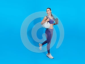 Go to training fitness. Happy Asian sporty woman with bag on blue background. Sports and healthy lifestyle