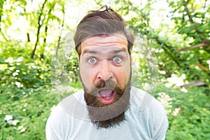 Go wild. Crazy bearded man in natural environment. Hipster with long beard emotional face close up nature background