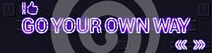GO YOUR OWN WAY glowing purple neon lamp sign on a black electric wall