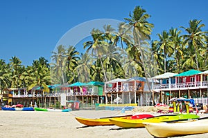 Goa beach Palolem India, colorful bungalows under the palm tree photo