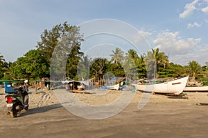 Goa, India - December 20, 2018: Fishermen prepare tackle and boats on Morjim Beach