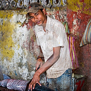 Goa, India - February 2008 - Young man slicing a large fresh fish at the famous weekly Mapusa Market