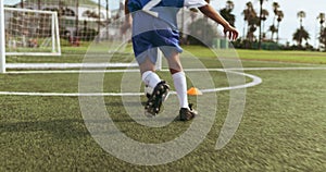 Goal, ball and feet of soccer child shooting practice for competition match, target aim or youth workout drill. Football