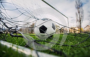 Goal concept as a soccer ball enters the gate and hits the net. Football championship background, spring outdoors tournaments on