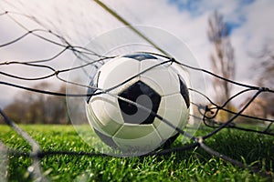 Goal concept as a soccer ball enters the gate and hits the net. Football championship background, spring outdoors tournaments on