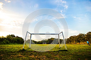 Goal football in the park with a sun light.