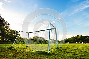 Goal football in the park with a sun light.