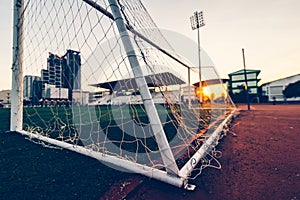 Goal football at sport stadium and sunset