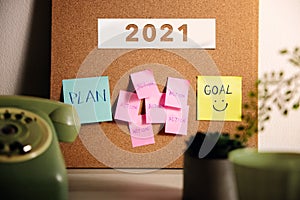 Goal, Plan, Challenge and Strategy for 2021 Year Concept. Sticky Note on Cork Board on Working Desk