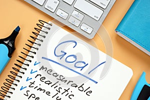 Goal setting concept. Notepad with pen on desk