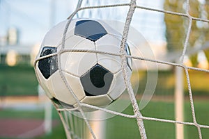 Goal - soccer or football ball in the net in stadium