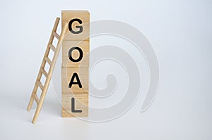 Goal text on wooden cubes with ladder on white background