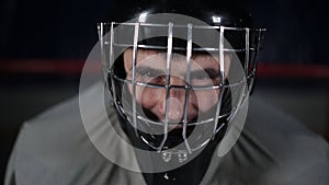 Goalie hockey player waiting for the enemy stands at the gate. Close-up goalie helmet.