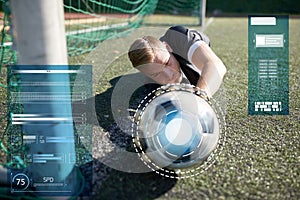 Goalkeeper with ball at football goal on field