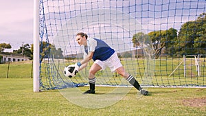 Goalkeeper in blue making a save