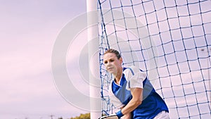 Goalkeeper in blue making a save