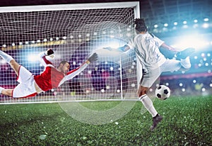 Goalkeeper catches the ball in the stadium during a football game.