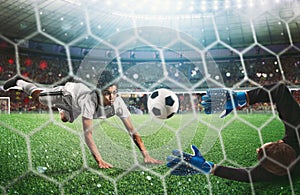 Goalkeeper catches the ball in the stadium during a football game.