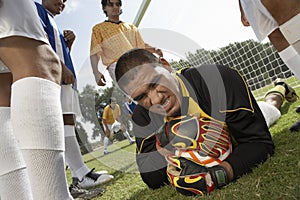 Goalkeeper Diving Ahead To Catch The Ball