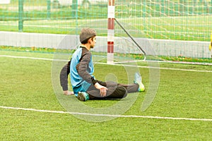 Goalkeeper and goal at the football field, warms up before soccer game