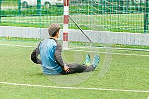 Goalkeeper and goal at the football field, warms up before soccer game