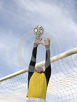 Goalkeeper Jumping To Catch The Ball