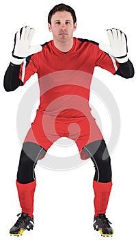 Goalkeeper in red ready to catch