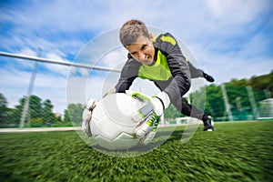 Goalkeeper soccer man catching ball action sport moment