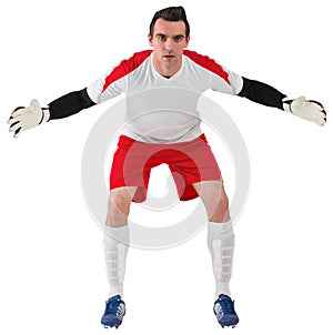 Goalkeeper in white ready to save
