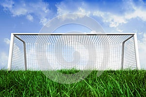 Goalpost on grass under blue sky