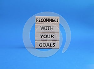 Goals symbol on Wooden blocks Beautiful blue background. Business and 'Reconnect with you