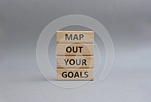 Goals symbol. Wooden blocks with words Map out your goals. Beautiful grey background. Business and Map out your goals concept.