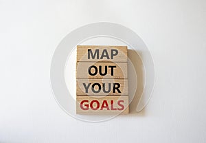 Goals symbol. Wooden blocks with words Map out your goals. Beautiful white background. Business and Map out your goals concept