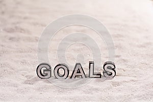 Goals word on white sand