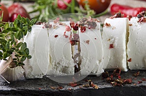 Goat cheese with red pepper on a slate plate